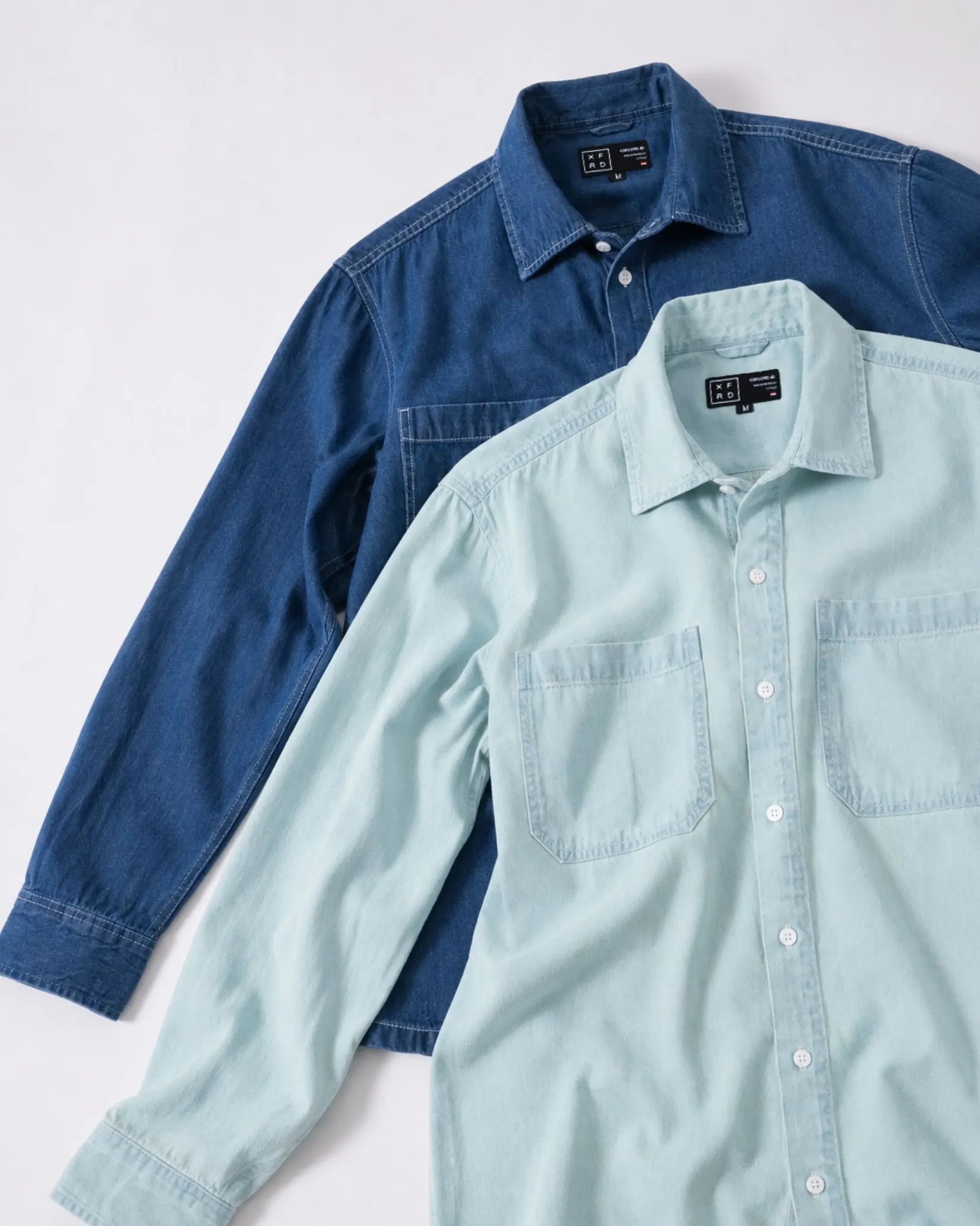 Indigo and light blue Denim Shirts arranged together.